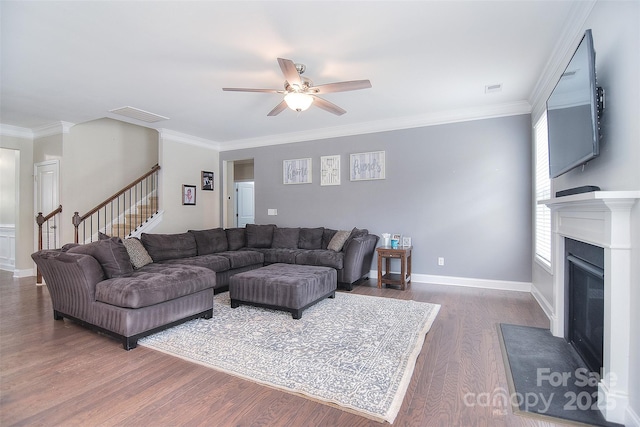 2014 Burton Point Ct, Waxhaw, NC 28173 - living room with dark wood-style flooring, a ceiling fan, stairway, crown molding, and a fireplace