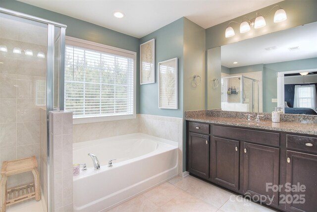 2014 Burton Point Ct, Waxhaw, NC 28173 - bathroom featuring a stall shower, a garden tub, vanity, tile patterned floors, and recessed lighting