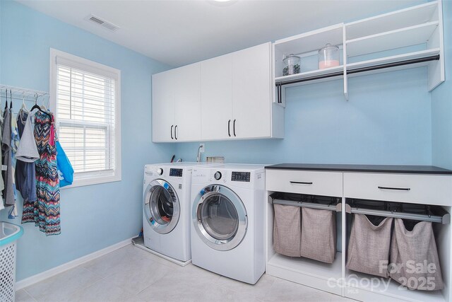 2014 Burton Point Ct, Waxhaw, NC 28173 - laundry room with cabinet space, washer and dryer, and light tile patterned flooring
