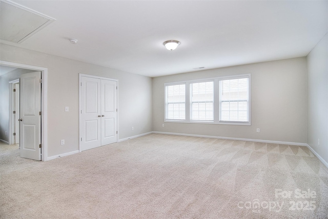 2014 Burton Point Ct, Waxhaw, NC 28173 - unfurnished bedroom featuring attic access, light colored carpet, and a closet