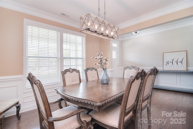 2014 Burton Point Ct, Waxhaw, NC 28173 - dining room with dark wood-type flooring, ornamental molding, wainscoting, a decorative wall, and a chandelier