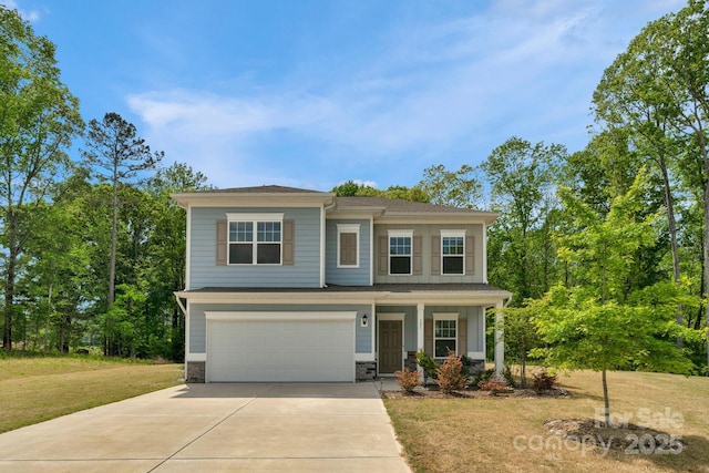 view of front of property with a front lawn, driveway, stone siding, a porch, and a garage