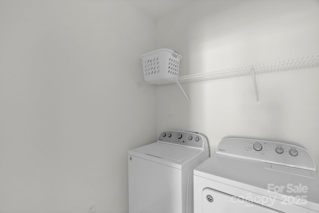 clothes washing area with independent washer and dryer and laundry area