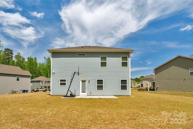 rear view of house with a lawn and a patio