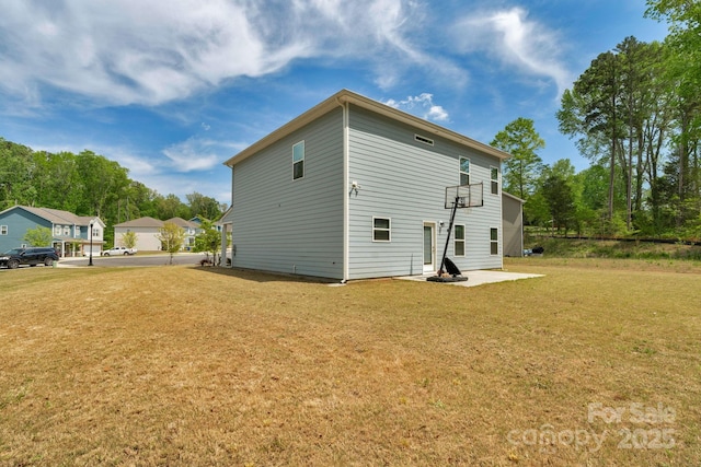 back of house featuring a yard and a patio