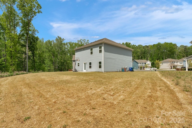 back of property with a yard