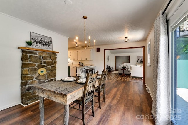 dining room with an inviting chandelier, dark wood finished floors, and crown molding