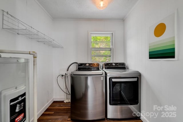 laundry area featuring laundry area, crown molding, washing machine and dryer, dark wood-style floors, and a textured ceiling