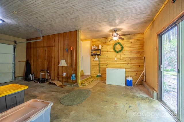 garage with wooden walls and ceiling fan