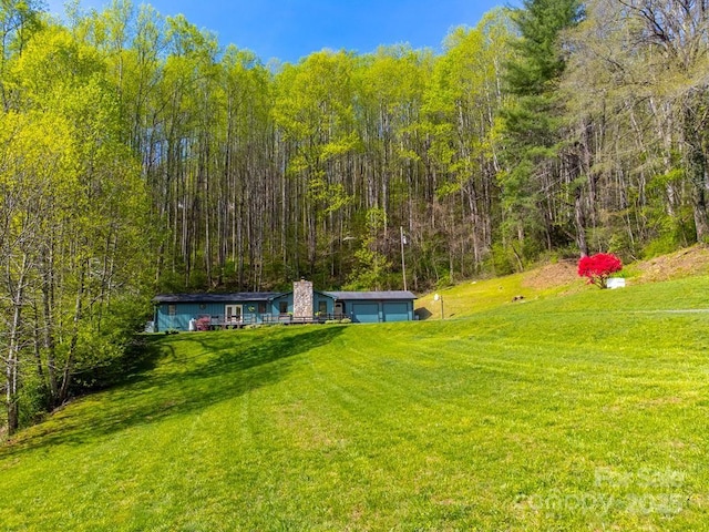 view of yard featuring a wooded view