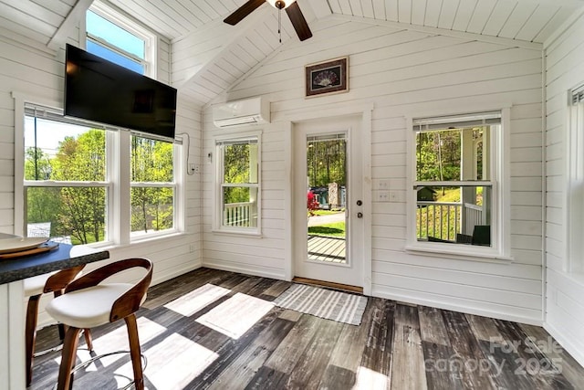 sunroom featuring an AC wall unit, wood walls, wood-type flooring, and lofted ceiling with beams