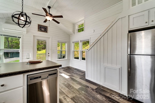 kitchen with wood ceiling, dark countertops, appliances with stainless steel finishes, vaulted ceiling, and a wall mounted air conditioner