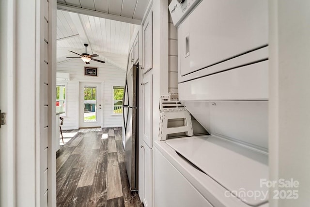 clothes washing area featuring laundry area, stacked washer and dryer, dark wood-style floors, wood ceiling, and a ceiling fan