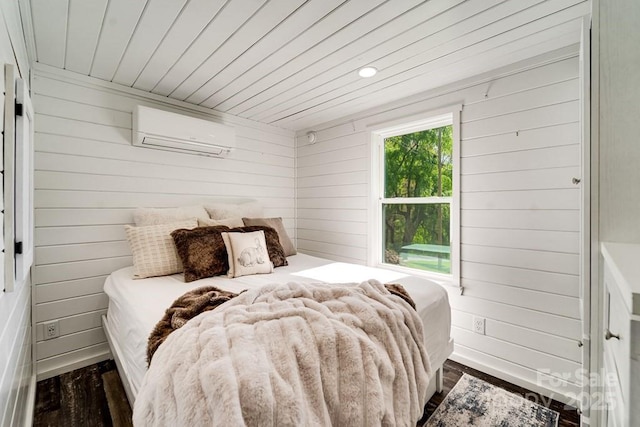 bedroom with baseboards, wood walls, wood ceiling, and a wall unit AC