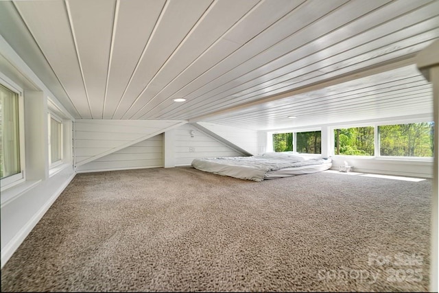 unfurnished bedroom with carpet floors and wood ceiling