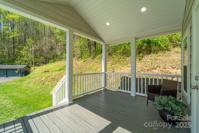 wooden deck featuring a yard and a porch