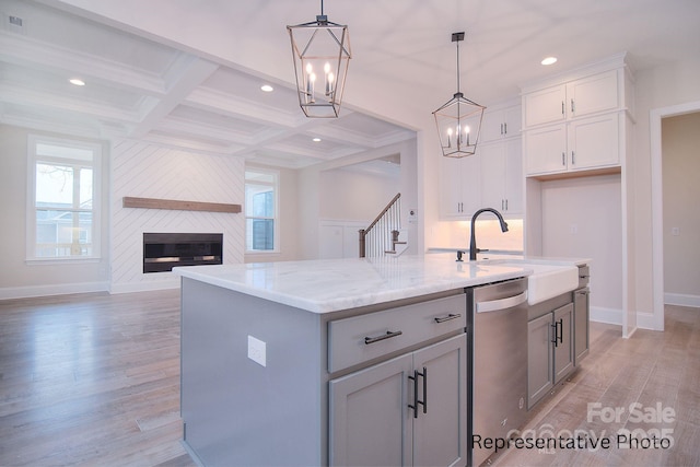 kitchen with stainless steel dishwasher, recessed lighting, gray cabinets, and light wood-type flooring
