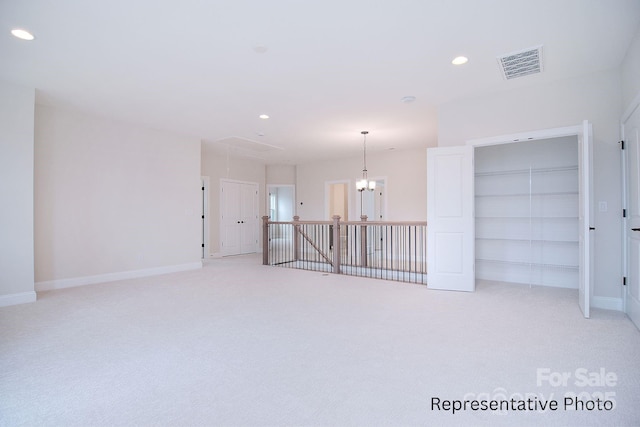 spare room featuring baseboards, light carpet, recessed lighting, and visible vents