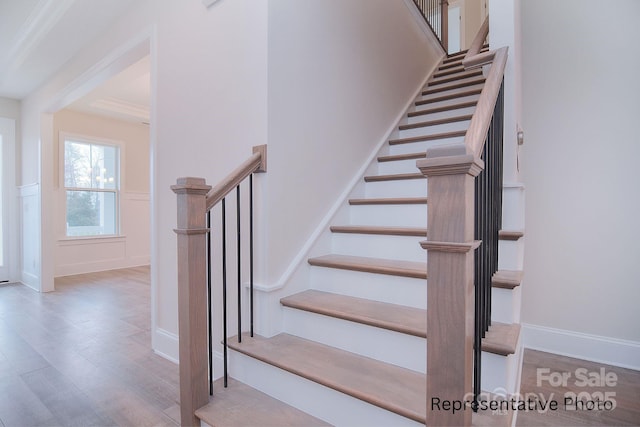 stairs with baseboards and wood finished floors