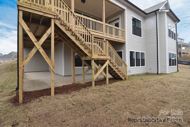 back of house with a wooden deck, a yard, a patio area, and stairway