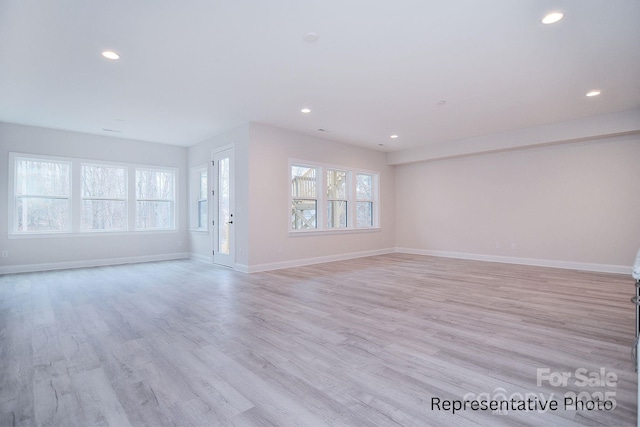 unfurnished living room with light wood-style floors, baseboards, and recessed lighting