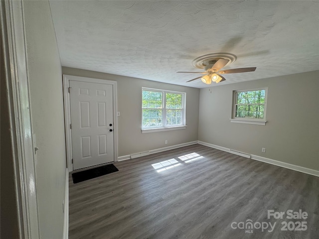 2703 34th Street Pl NE, Hickory, NC 28601 - interior space with dark wood-type flooring, a healthy amount of sunlight, and a ceiling fan