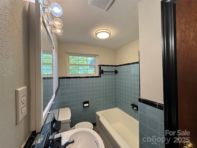 2703 34th Street Pl NE, Hickory, NC 28601 - bathroom featuring tile walls, visible vents, toilet, and a wainscoted wall