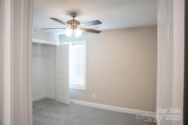 unfurnished bedroom with a ceiling fan, a closet, light colored carpet, baseboards, and visible vents