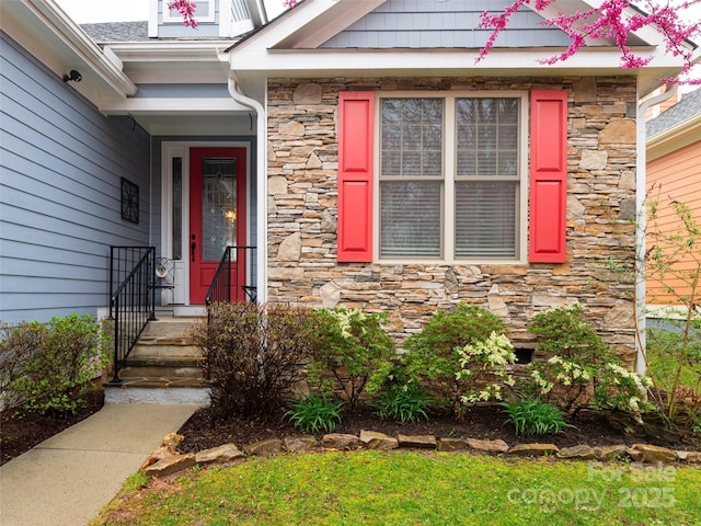 doorway to property featuring stone siding