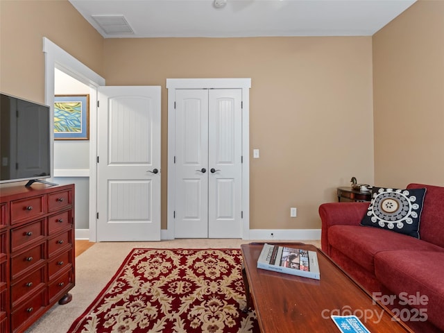 living area featuring baseboards and visible vents