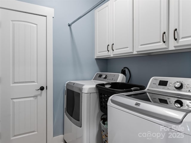 laundry area featuring independent washer and dryer and cabinet space