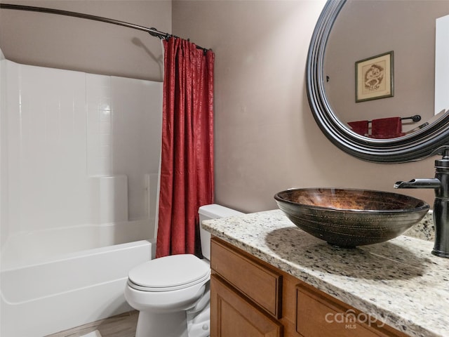bathroom featuring shower / tub combo with curtain, vanity, and toilet