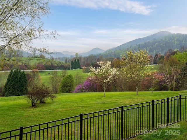 view of yard with fence and a mountain view