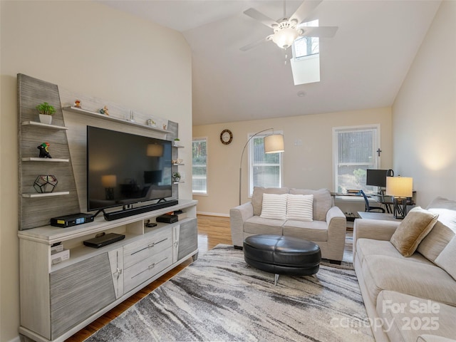 210 Allen Paul Dr, Hendersonville, NC 28791 - living room featuring a skylight, wood finished floors, ceiling fan, and a healthy amount of sunlight