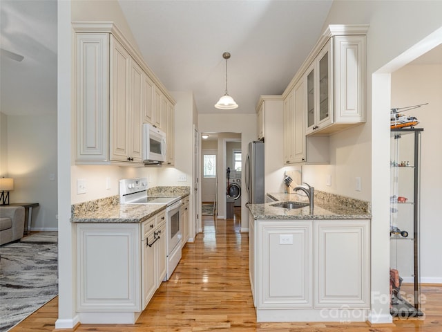 210 Allen Paul Dr, Hendersonville, NC 28791 - kitchen with a sink, light wood-style floors, glass insert cabinets, white appliances, and light stone counters