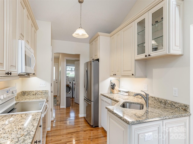 210 Allen Paul Dr, Hendersonville, NC 28791 - kitchen featuring a sink, white appliances, glass insert cabinets, light wood-style flooring, and hanging light fixtures