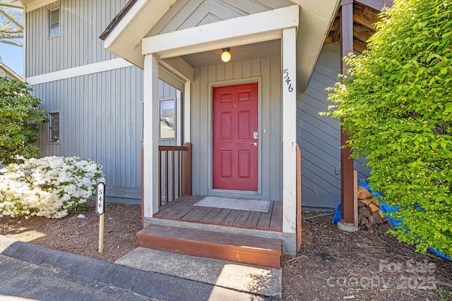 view of exterior entry with board and batten siding