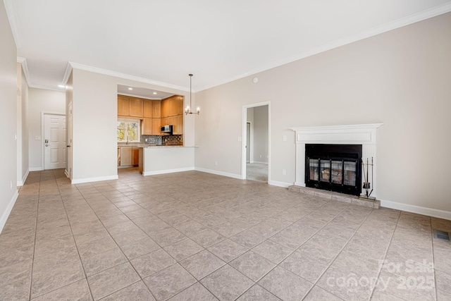 unfurnished living room with recessed lighting, ornamental molding, light tile patterned floors, a chandelier, and a glass covered fireplace
