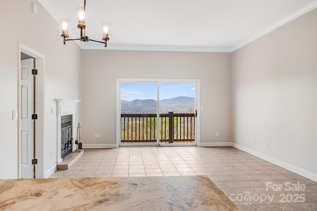 unfurnished living room featuring a notable chandelier, ornamental molding, tile patterned flooring, and a mountain view