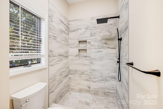 full bath with toilet and tiled shower