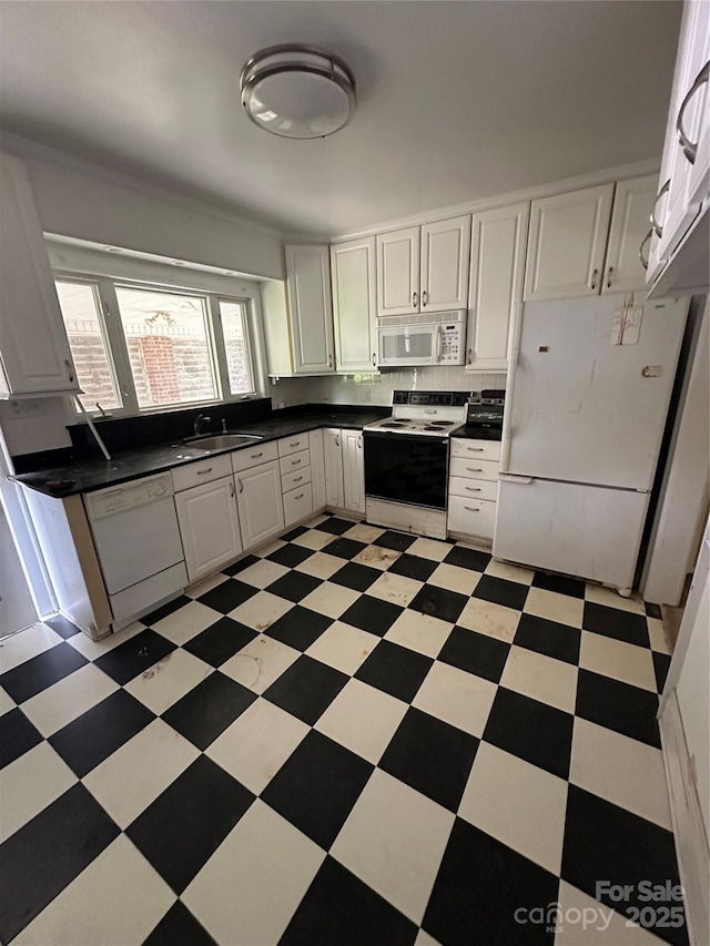 404 S Mulberry St, Cherryville, NC 28021 - kitchen featuring white cabinets, a sink, dark countertops, white appliances, and light floors