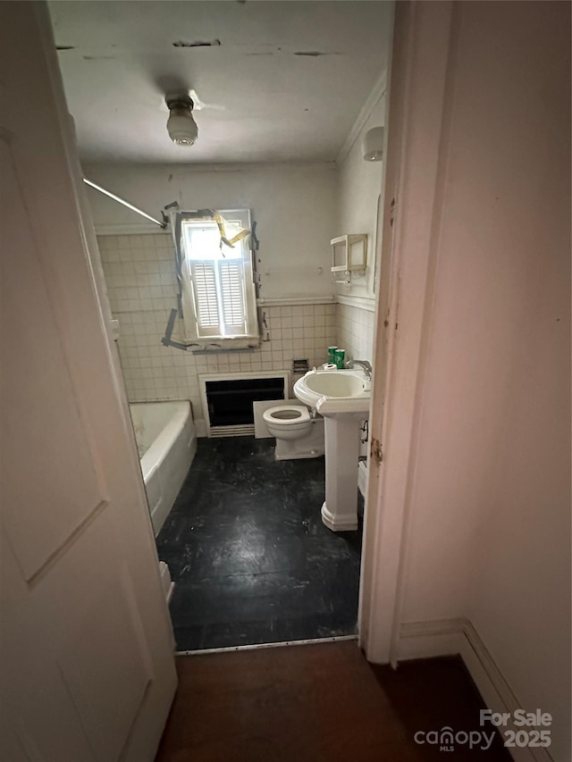 404 S Mulberry St, Cherryville, NC 28021 - full bath with wainscoting, toilet, washtub / shower combination, and tile walls
