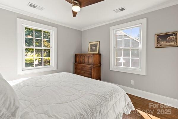241 Wakefield Dr Unit C, Charlotte, NC 28209 - bedroom with multiple windows, wood finished floors, visible vents, and crown molding