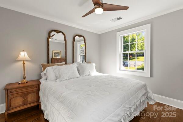 241 Wakefield Dr Unit C, Charlotte, NC 28209 - bedroom with visible vents, a ceiling fan, ornamental molding, dark wood-type flooring, and baseboards