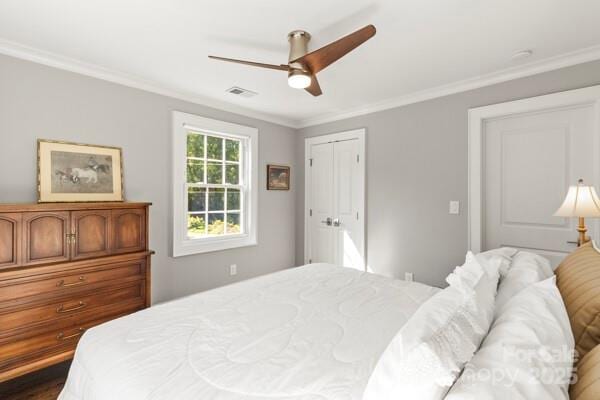 241 Wakefield Dr Unit C, Charlotte, NC 28209 - bedroom with a ceiling fan, visible vents, a closet, and crown molding