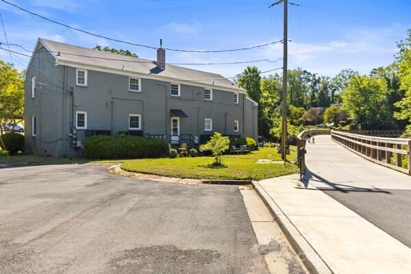 241 Wakefield Dr Unit C, Charlotte, NC 28209 - exterior space with a lawn and a chimney