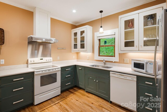 kitchen with white cabinets, a sink, white appliances, ornamental molding, and green cabinets
