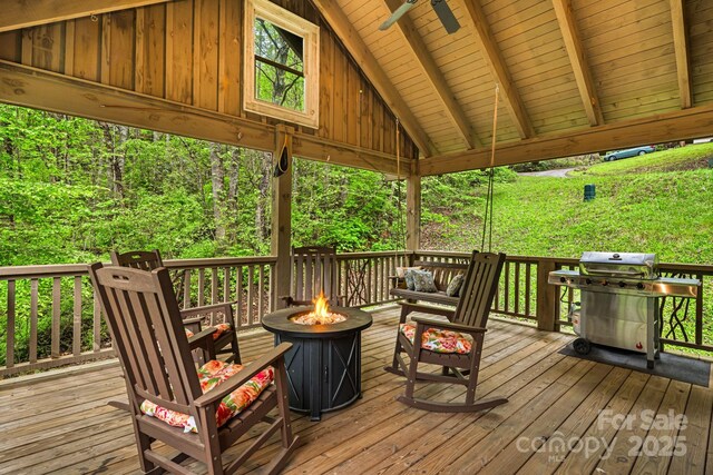 deck featuring a fire pit and grilling area