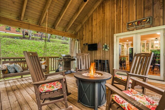sunroom / solarium featuring french doors and beam ceiling