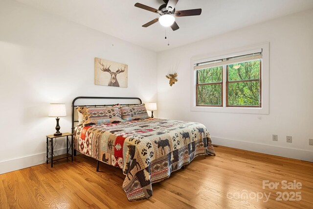 bedroom with baseboards, ceiling fan, and wood finished floors